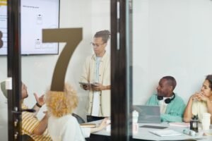 Diverse team collaborating on plans in a modern meeting room
